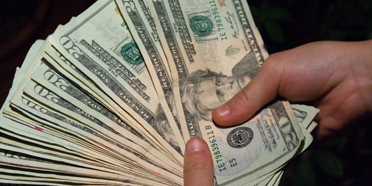"Money Hand Holding Bankroll Girls February 08, 20117" by stevendepolo is marked with CC BY 2.0.