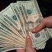 "Money Hand Holding Bankroll Girls February 08, 20117" by stevendepolo is marked with CC BY 2.0.